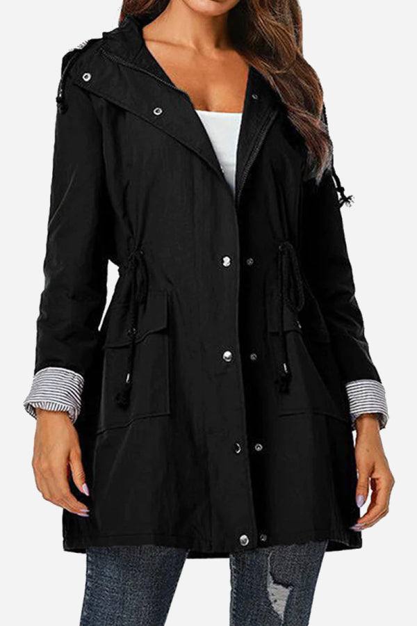 Women's black water resistant hooded windbreaker jacket with striped cuffs and front pockets