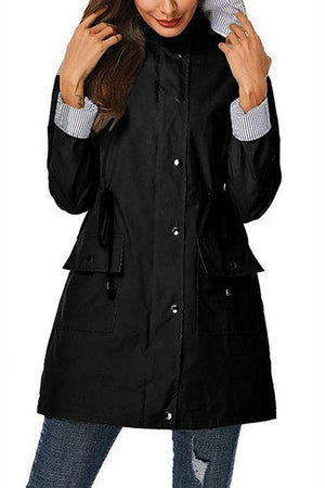 Women's black water resistant windbreaker jacket with hood and striped cuffs