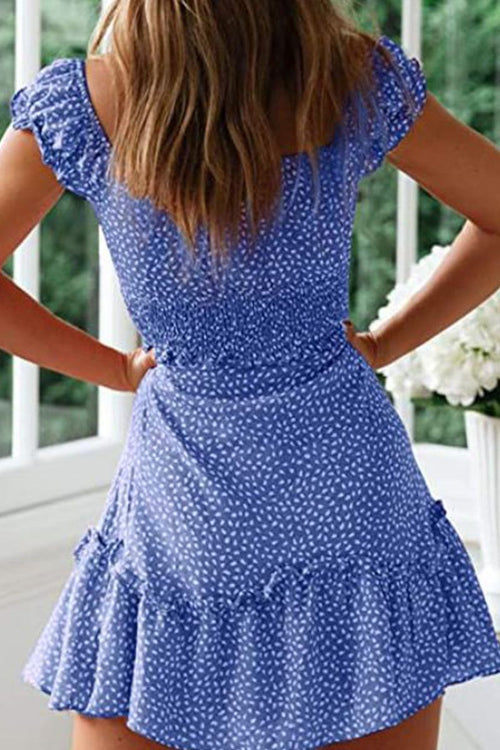 Back view of woman wearing blue sweetheart collar printed ruffled maxi dress with short ruffled sleeves and high waist design