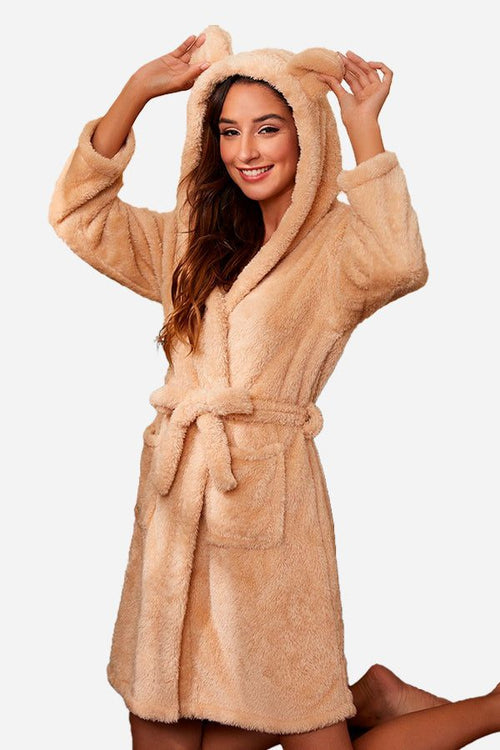 Woman wearing beige premium comfort nightgown bathrobe with hood and ears, belted waist, and front pockets