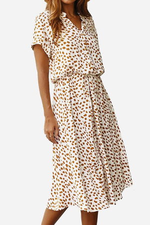 Woman wearing a casual bohemian dress skirt with a brown dot print and lace-up waist