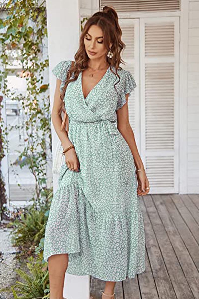 Woman wearing Elegant Blossoms Boho Maxi Dress with floral print and ruffled sleeves on wooden porch