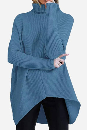 Blue cozy oversized knit pullover with high neck and long sleeves on model
