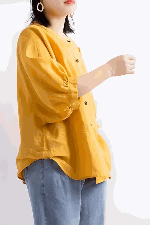 Relaxed loose breathable linen blouse in bright yellow with button-down front and 3/4 puff sleeves worn with blue jeans