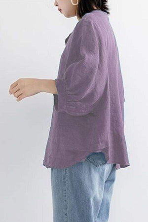 Relaxed loose breathable linen blouse in purple with long sleeves and casual fit, styled with jeans