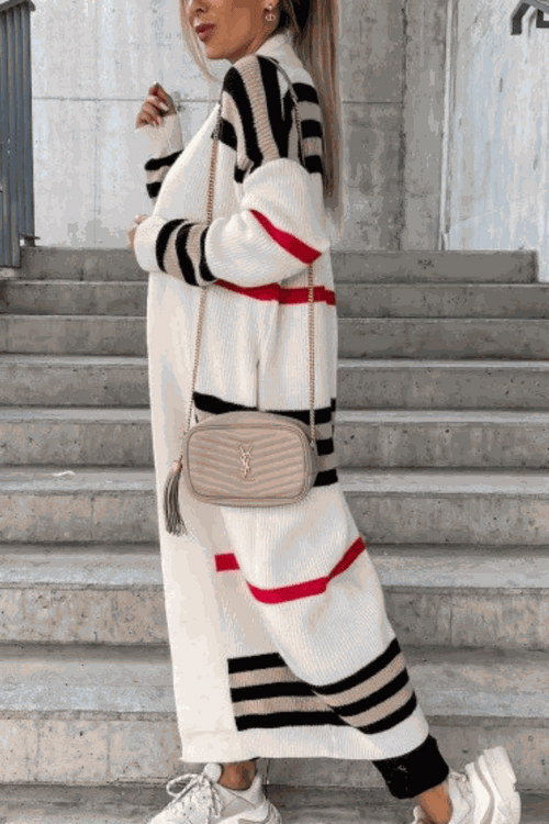 Cozy striped long knitted cardigan with oversized fit and soft fabric worn with crossbody bag and sneakers