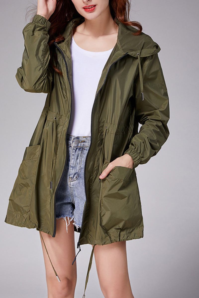 Travel ready outdoor raincoat windbreaker in olive green, lightweight waterproof jacket with hood and pockets.