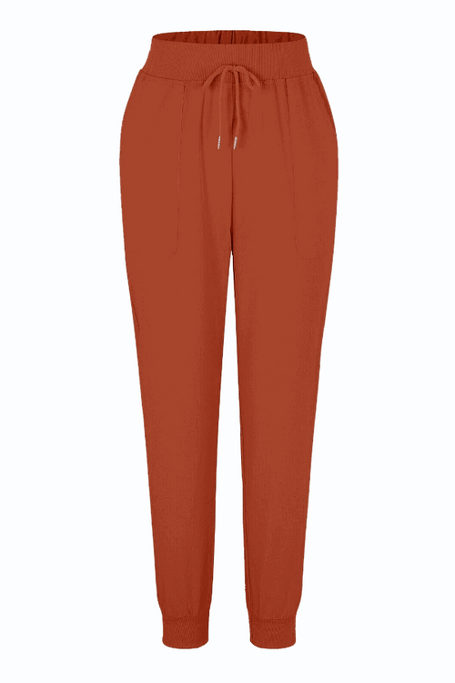 rust-colored relaxed chic elastic ankles pants with drawstring waist and tapered fit