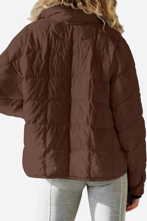 back view of lightweight puffer travel jacket in brown on model