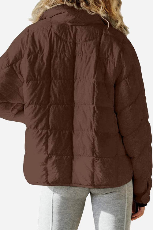 back view of lightweight puffer travel jacket in brown on model