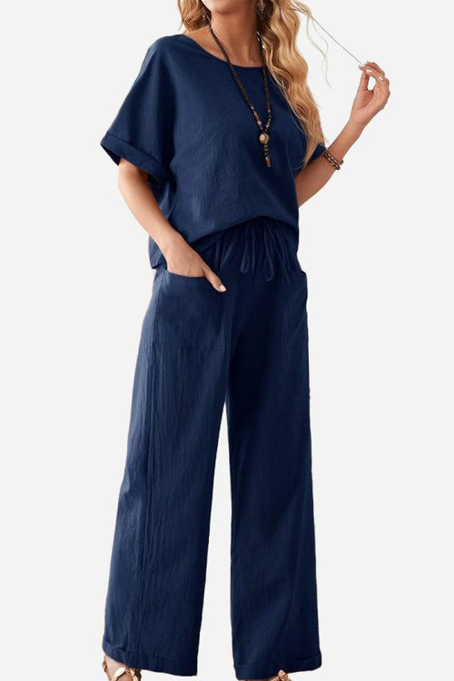 Woman wearing navy rolled cuff top and patch pocket pants set in relaxed fit