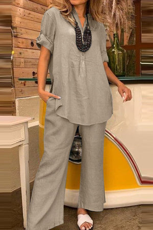 Woman wearing short-sleeved V-neck top and wide trouser suit in light cotton fabric