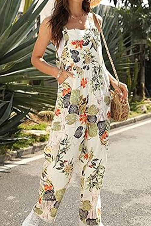 Woman wearing floral print Bohemian Fantasy Overalls with square neckline and wide legs outdoors