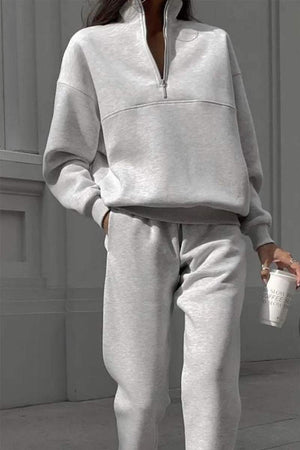 Grey cotton-blended two-piece tracksuit with high collar and deep zipper, styled for casual comfort and outside wear.