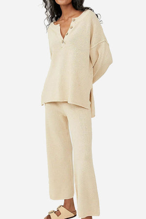 Woman wearing beige two-piece oversized set with long sleeves and wide pants for multi-weather comfort