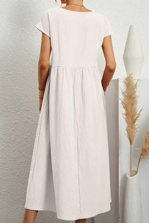 Back view of a white capped-sleeve voluminous pleated midi dress on a mannequin