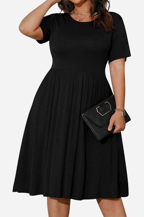 Black short-sleeved pleated dress with high waist and modest cut, featuring pockets and comfortable stretch fabric.