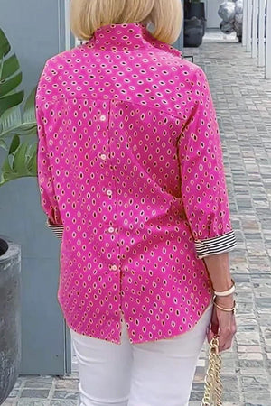Back view of pink Boho Chic Resort Blouse with polka dots and striped cuffs on woman wearing white pants