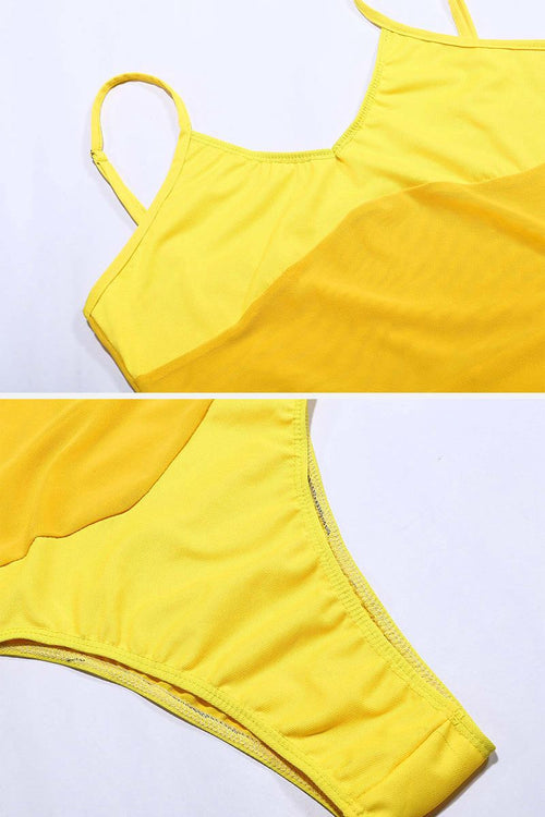 Close-up of yellow mesh tan-through one piece swimsuit fabric and stitching details