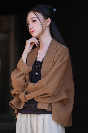 Woman wearing a brown ramie linen and cotton cardigan with relaxed fit and long sleeves