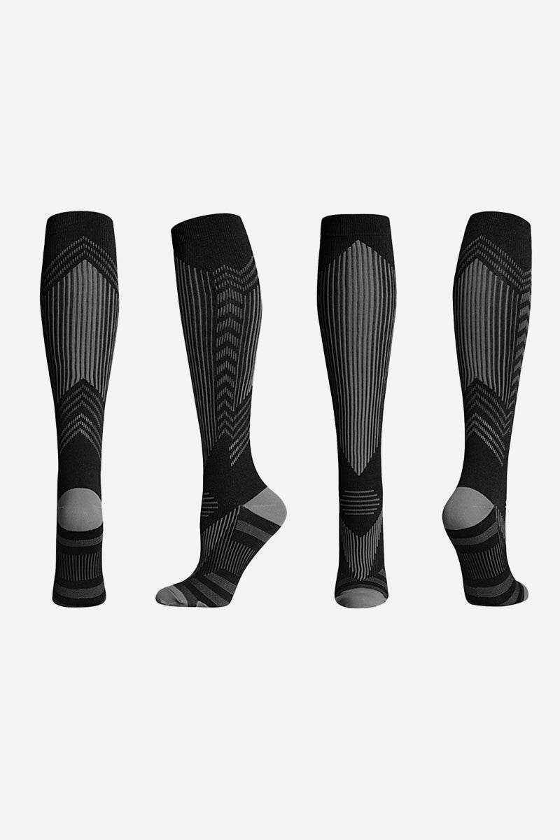 Black premium compression socks with gradual compression design for travel and leg fatigue relief, shown from multiple angles.