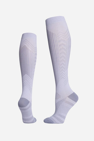 Light grey premium compression socks designed for travel with gradual compression and breathable fabric.