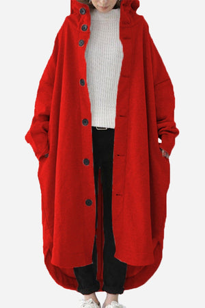 Woman wearing a red oversized everyday buttoned hooded coat with roomy pockets and relaxed fit