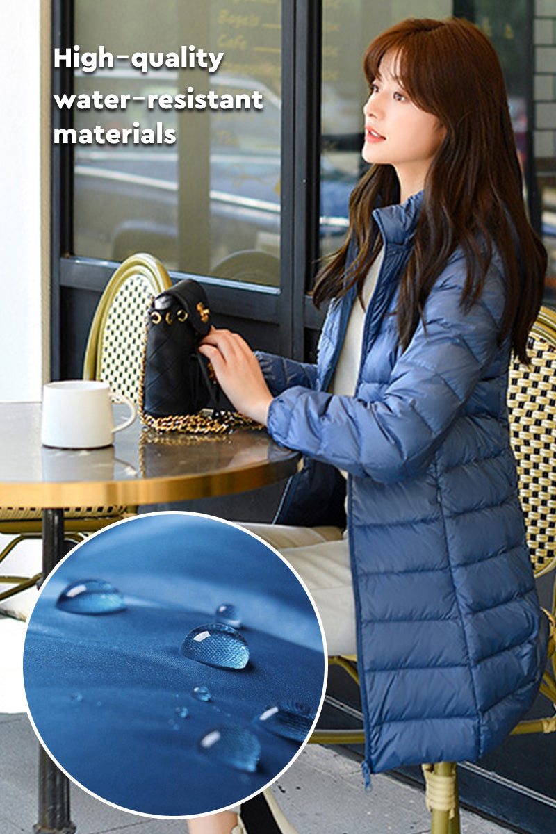 woman wearing lightweight water-resistant hooded puffer coat sitting at cafe table with close-up of water droplets on fabric