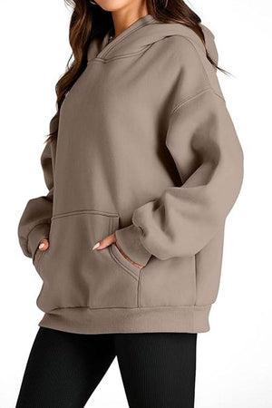 Oversized fleece-lined hoodie in taupe with kangaroo pocket and relaxed fit for cozy travel and casual wear
