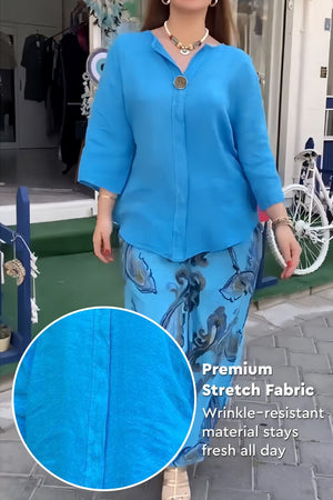 Woman wearing vibrant fusion two-piece set with blue top and patterned pants made of premium wrinkle-resistant stretch fabric