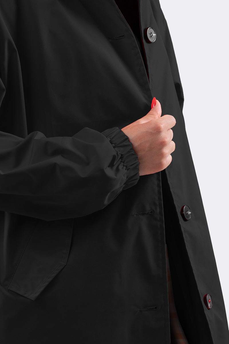 Close-up of black Travel-Smart Waterproof Hooded Windbreaker with button closure and elastic cuff on sleeve