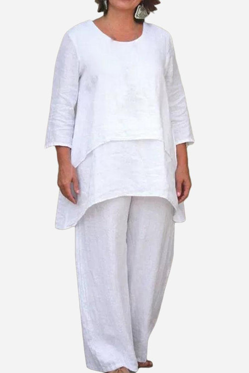 White loose drape two-piece set with asymmetrical oversized top and wide-leg pants.