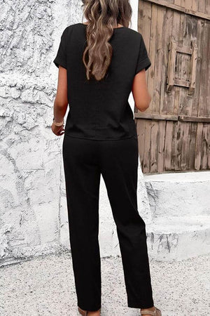 Woman wearing black 100% cotton total comfort two-piece travel set standing outdoors