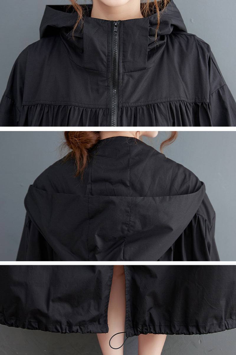 black oversized all-weather water-resistant windbreaker with hood and front zipper closure