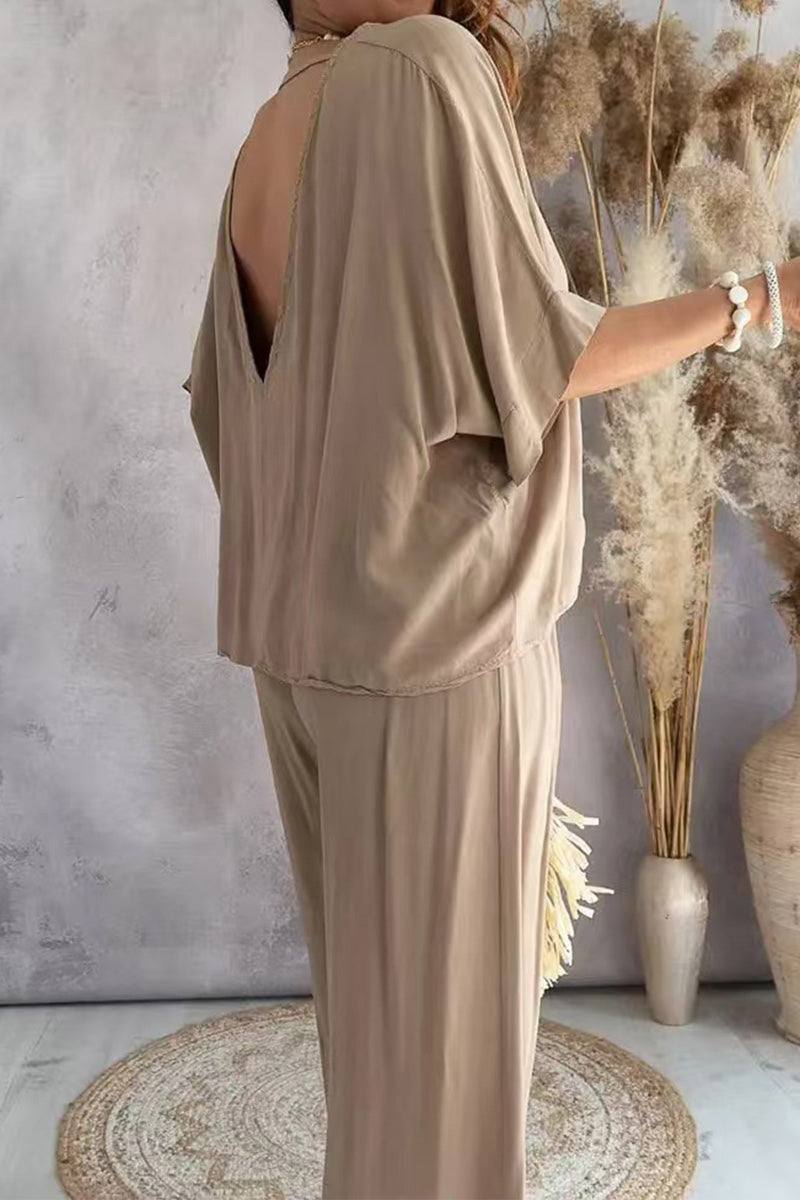 Beige two-piece pantsuit with V-neck and loose fit made of stretchy polyester fabric