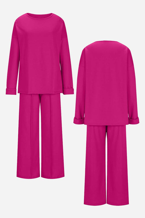 Bright pink comfortable travel-ready two-piece set with relaxed fit long sleeve top and wide-leg pants shown from front and back