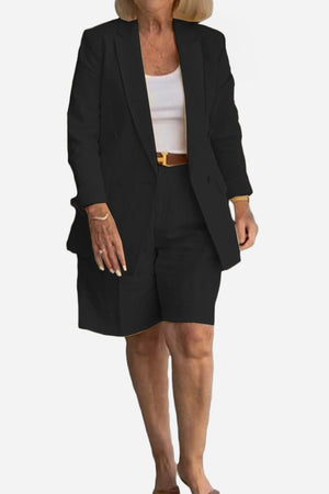 Stylish blazer and shorts two-piece set in black on a mature woman with white top and belt