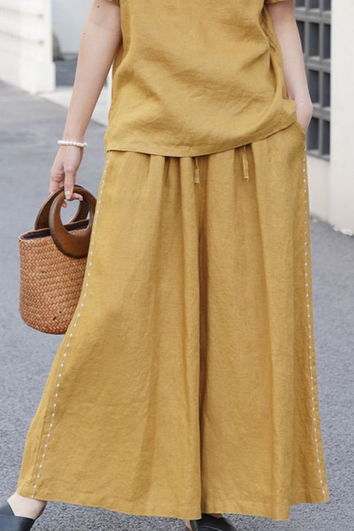 100% linen wide-leg pants in mustard yellow with elastic waist and breathable fabric