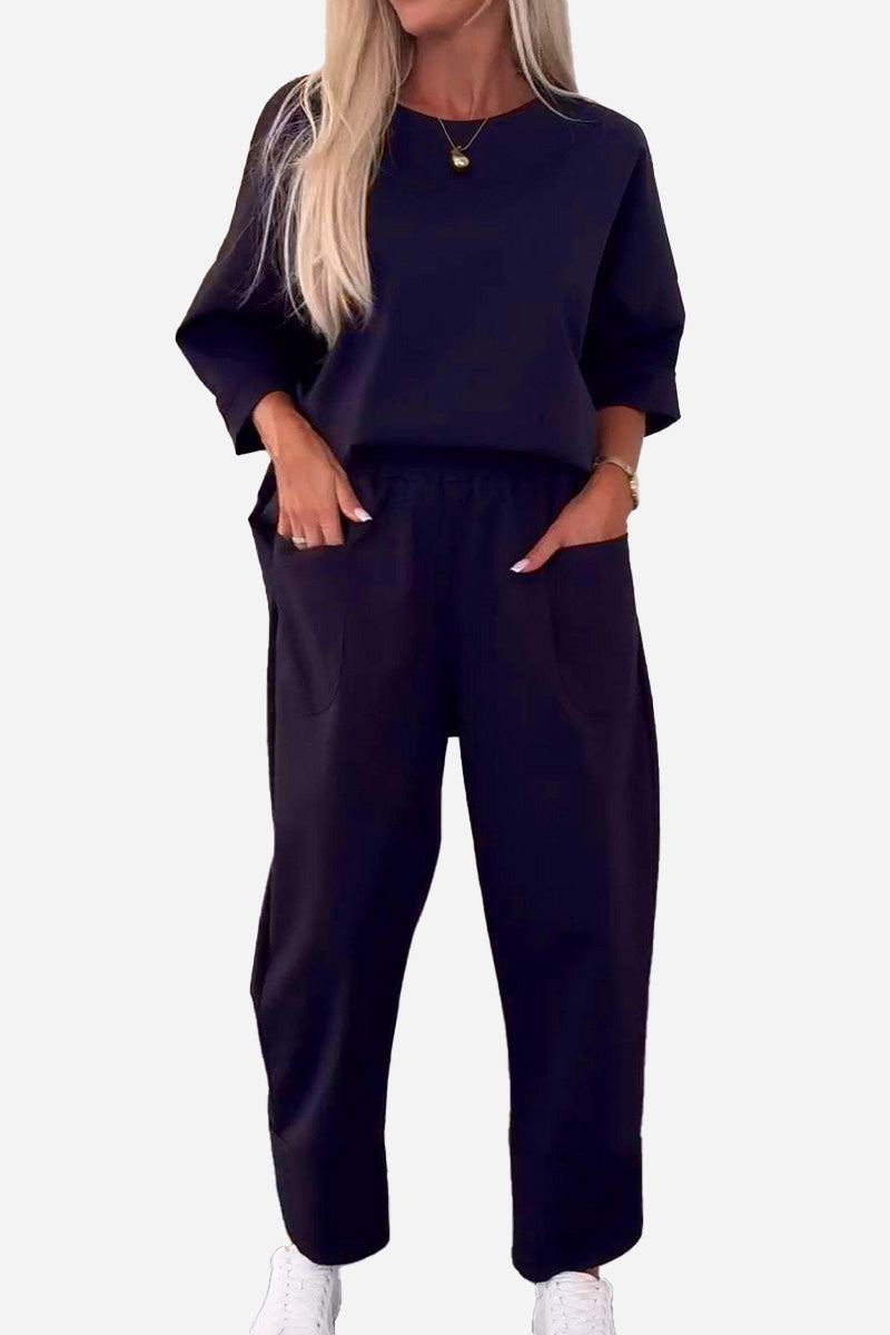 Women's black comfortable two-piece set with crew neck sweatshirt and jogger pants, wrinkle-resistant polyester fabric.