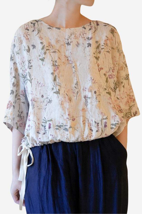Botanical Garden linen blouse with floral print and drawstring hem in soft breathable fabric.