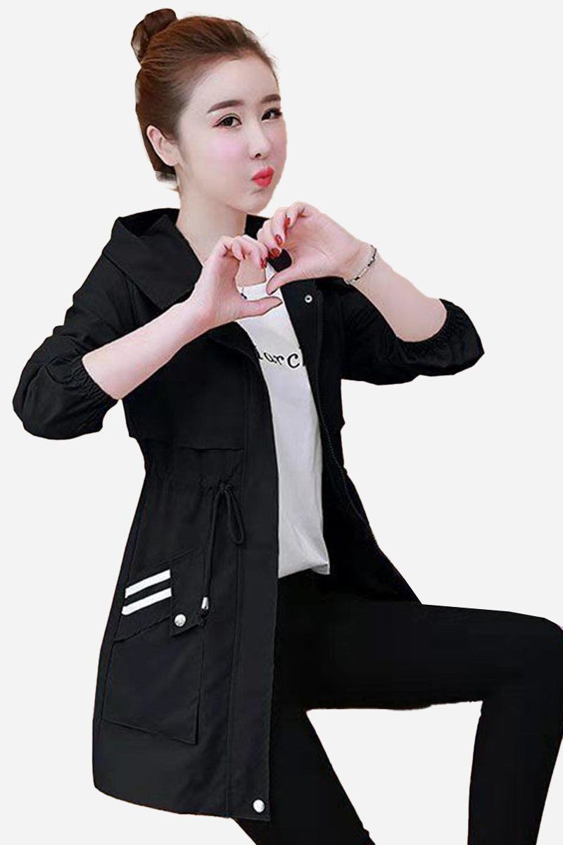 Woman wearing black Cityscape Comfort Hooded Windbreaker with mid-length fit and drawstring waist.