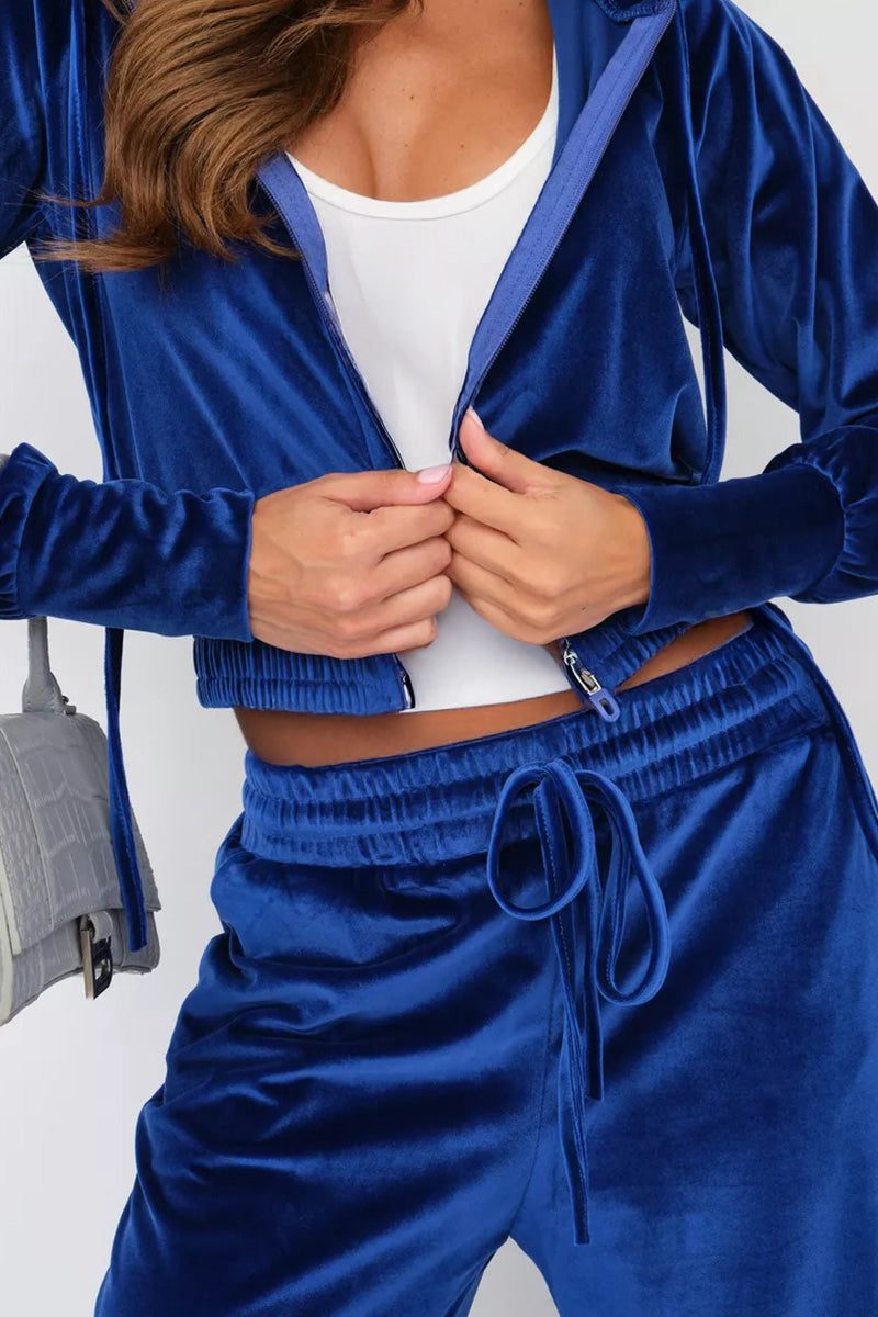 Modern cropped blue velour tracksuit with high-waist drawstring pants and smooth plush texture