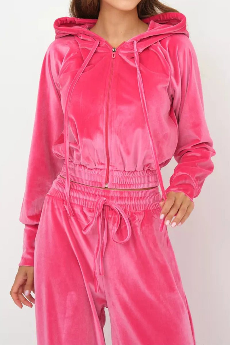 Pink velour tracksuit with cropped hoodie and high-waist drawstring pants in plush, smooth fabric