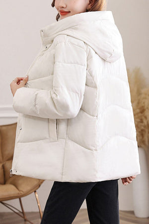 White mid-length Everyday Warmth Coat with hood and 5-layer thermal insulation worn by model