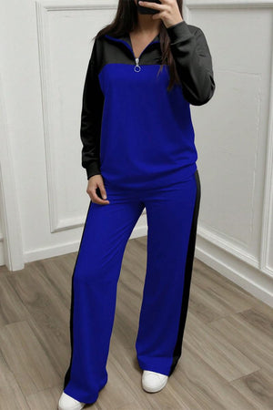 Woman wearing blue and black Colorblock Comfort Leisure Set with half-zip stand collar and wide-leg pants, styled for winter comfort and casual wear