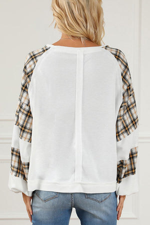 Waffle knit sweatshirt with white textured body and plaid flannel sleeves, relaxed fit back view