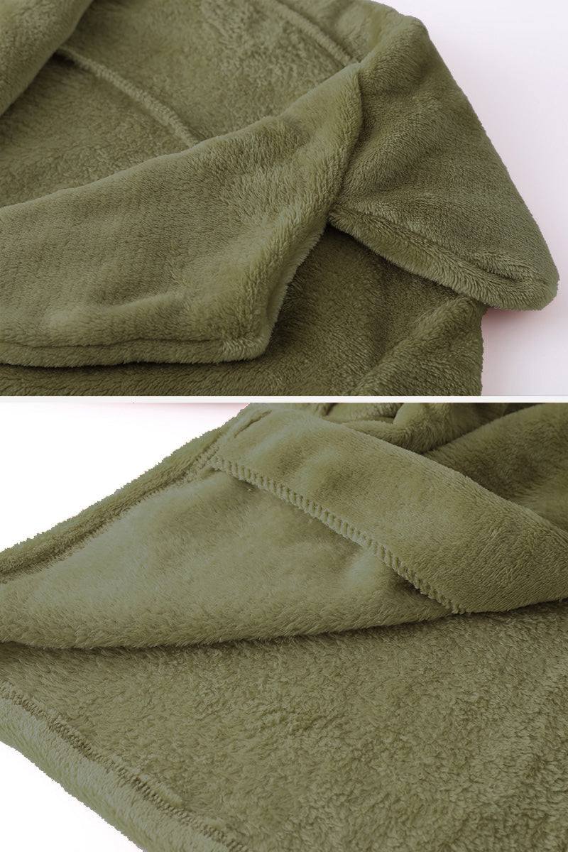 Close-up of soft olive green open front oversized faux fur jacket with plush texture and draped shawl collar