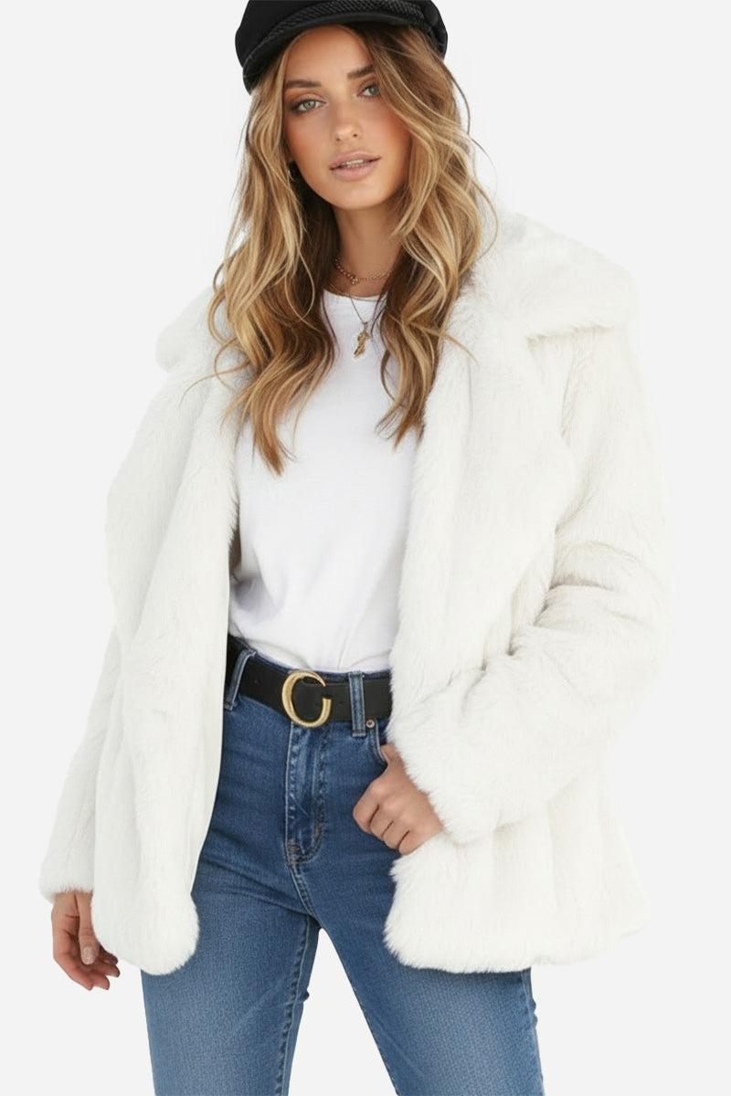 Woman wearing white open front oversized faux fur jacket with draped shawl collar and mid-hip length.