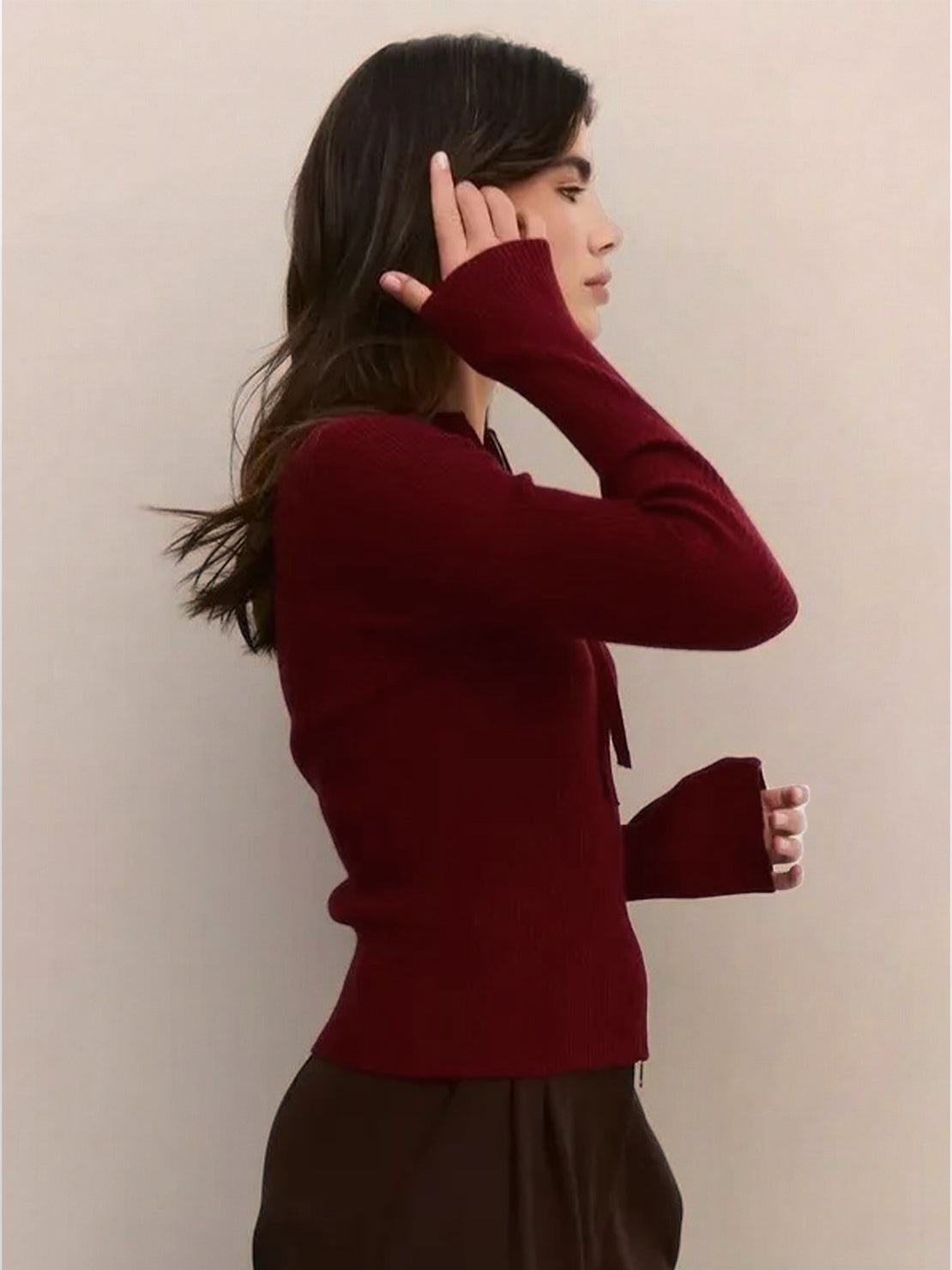 Front view of a ribbed zip-up knit cardigan jacket with high neckline and long sleeves, in a soft stretch fabric designed for a slim fit and comfortable all-day wear.