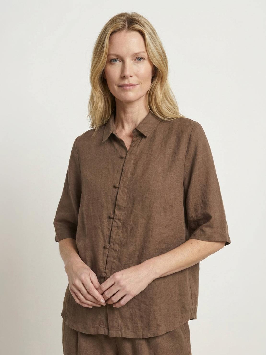 woman wearing 100% cotton artisan two-piece set with oversized button-front shirt and wide-leg pants